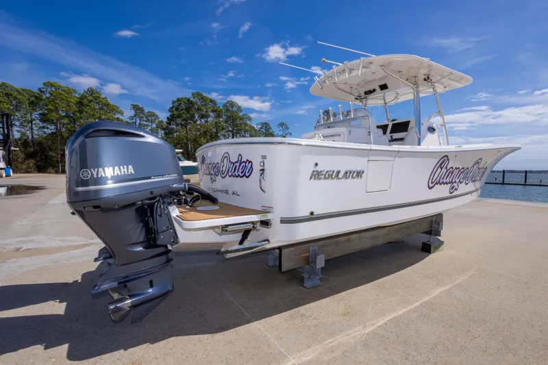 Slide: The Image of 2018 Regulator 31 boat with Yamaha engine, docked under clear blue sky. - 13