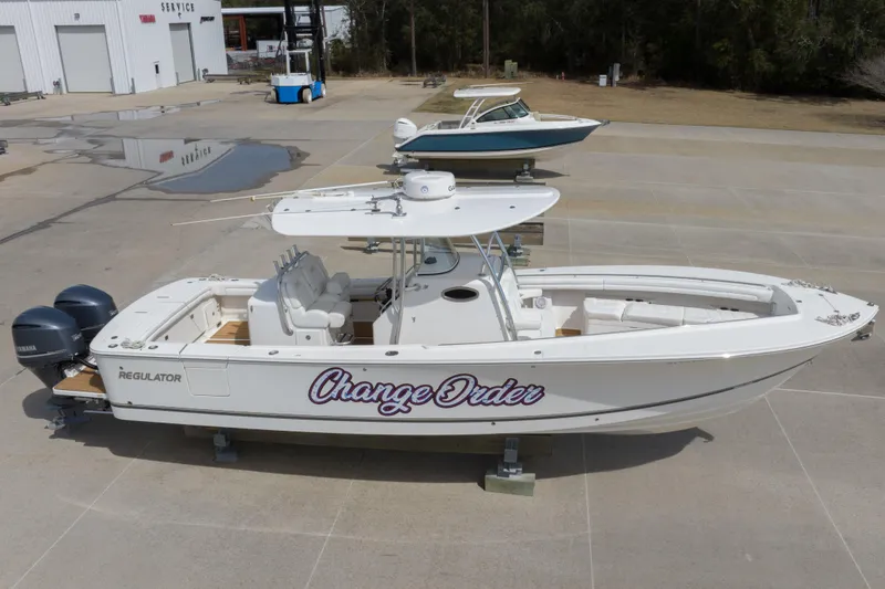 Slide: The Image of 2018 Regulator 31 boat on display with "Change Order" name, dual Yamaha engines. - 16