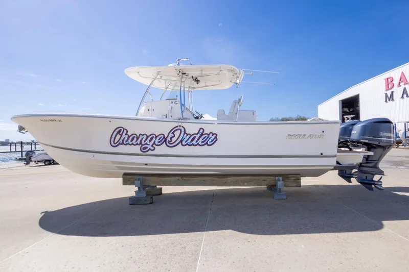 Slide: The Image of 2018 Regulator 31 boat on display at marina, featuring "Change Order" name. - 17