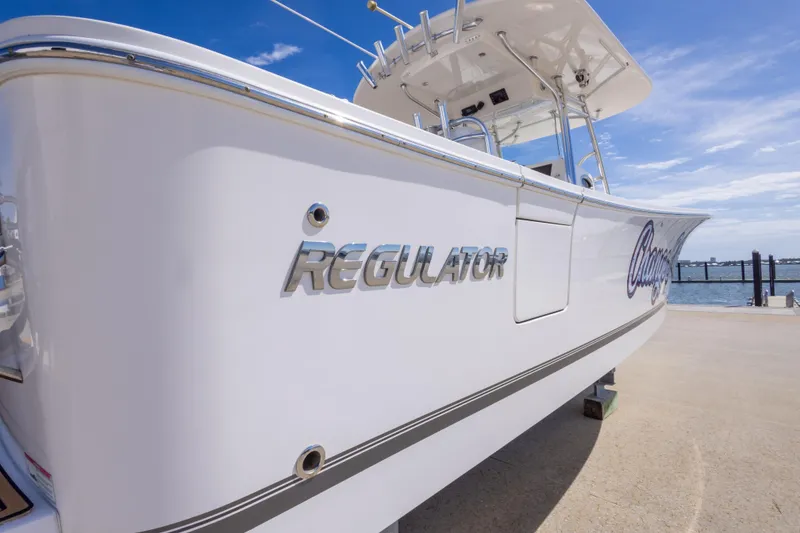 Slide: The Image of 2018 Regulator 31 boat docked under clear blue sky. - 18