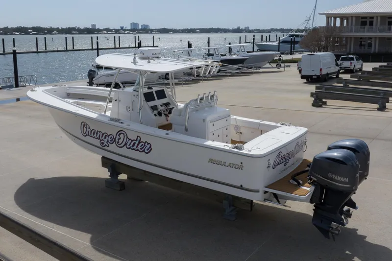 Slide: The Image of 2018 Regulator 31 boat with Yamaha engines docked by the waterfront. - 19