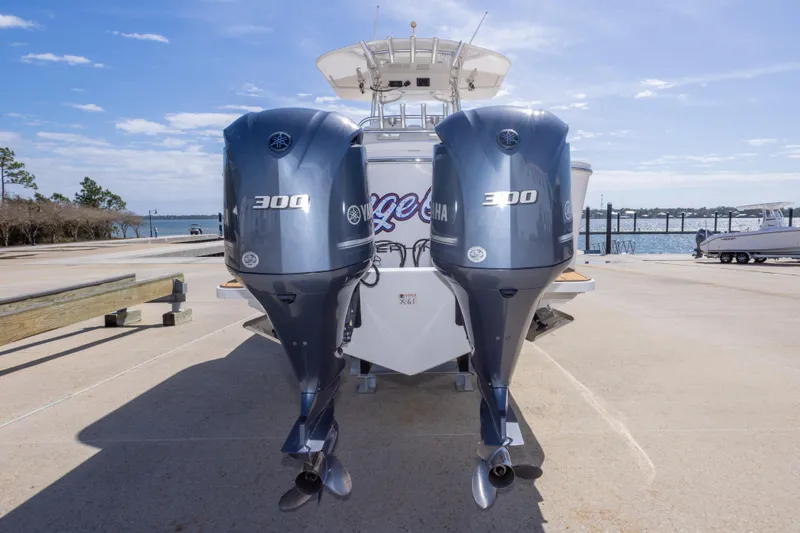 Slide: The Image of 2018 Regulator 31 boat with dual Yamaha 300 engines at a marina dock. - 20