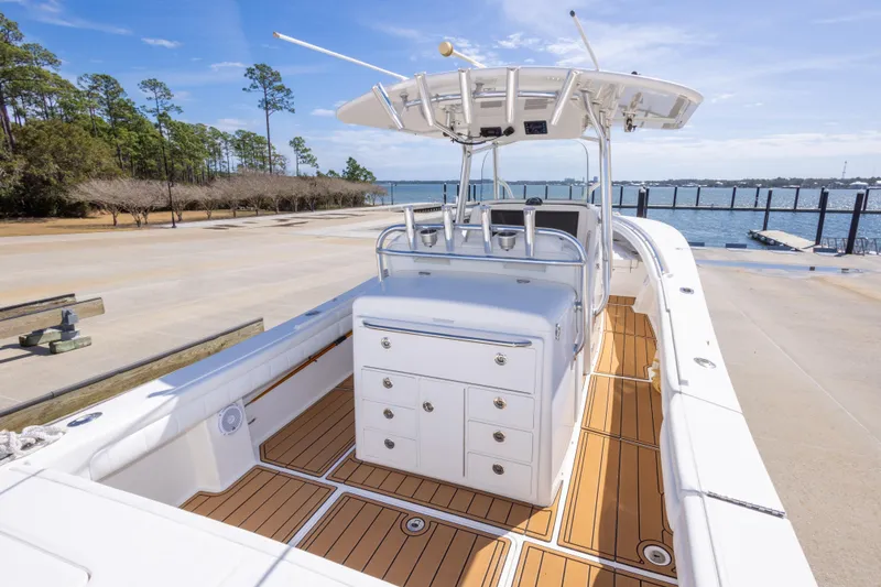 Slide: The Image of 2018 Regulator 31 boat with sleek design, spacious deck, and modern amenities by the water. - 24