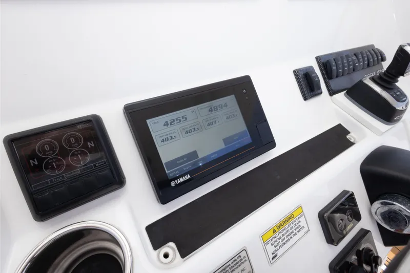 Slide: The Image of 2018 Regulator 31 boat dashboard with Yamaha controls and digital displays. - 30