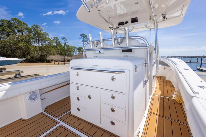 Slide: The Image of 2018 Regulator 31 boat interior with teak flooring and storage compartments. - 31