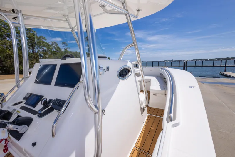 Slide: The Image of 2018 Regulator 31 boat cockpit with modern controls and ocean view. - 35