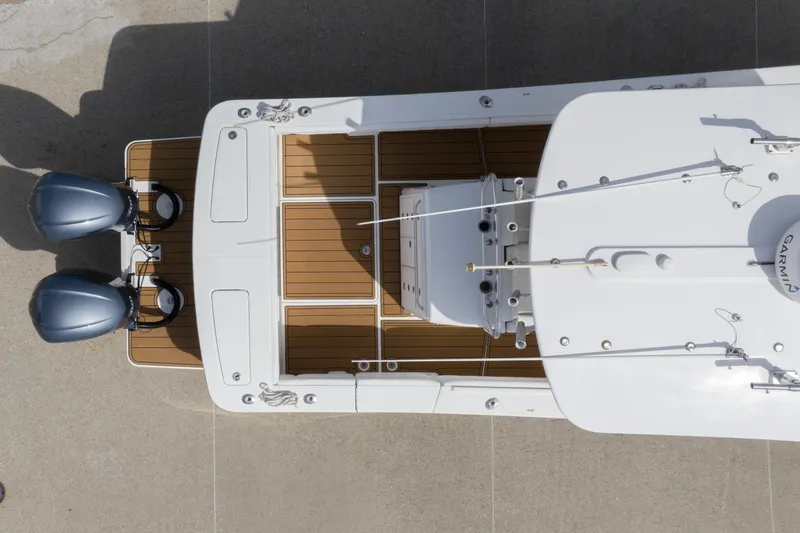 Slide: The Image of Aerial view of 2018 Regulator 31 boat with twin engines and wooden deck. - 4