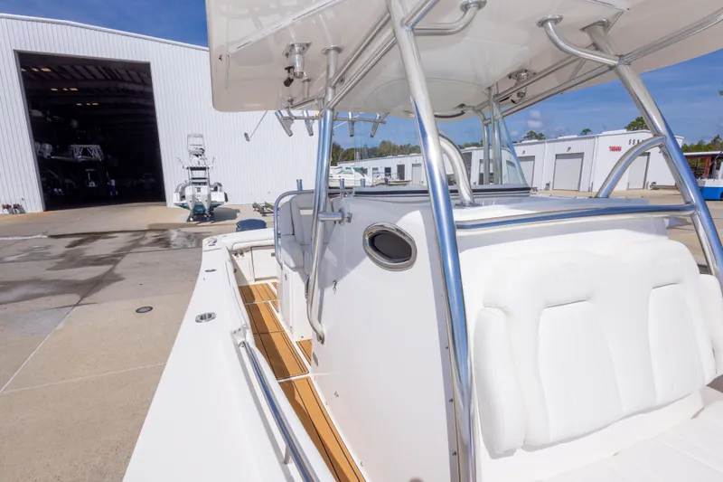 Slide: The Image of 2018 Regulator 31 boat at marina, showcasing sleek design and spacious deck. - 44