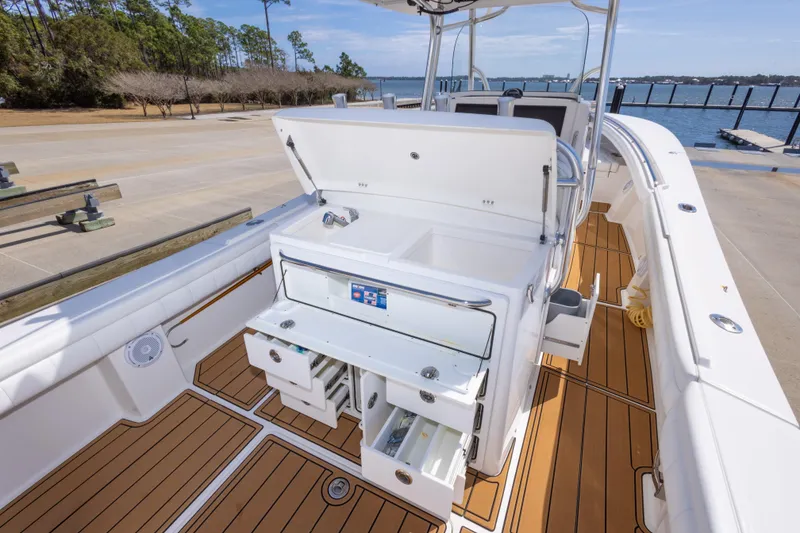 Slide: The Image of 2018 Regulator 31 boat interior with open storage compartments and teak flooring. - 45