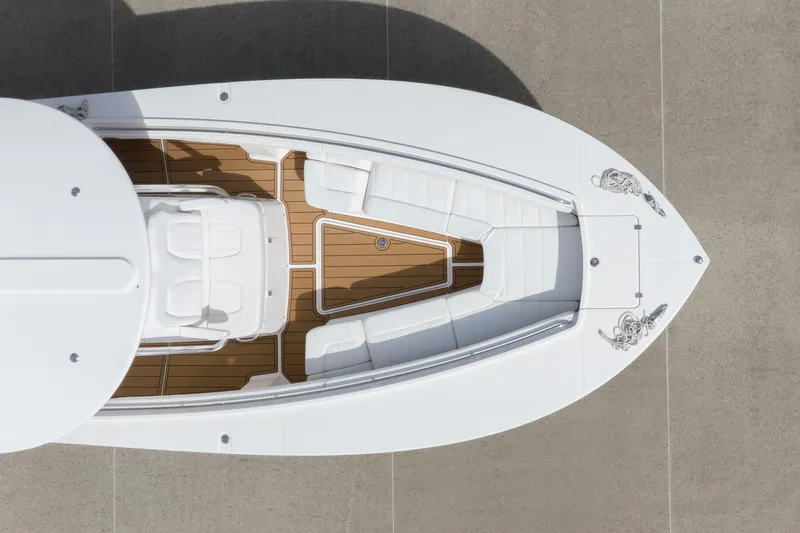Slide: The Image of Overhead view of 2018 Regulator 31 boat with white seating and wooden deck. - 5
