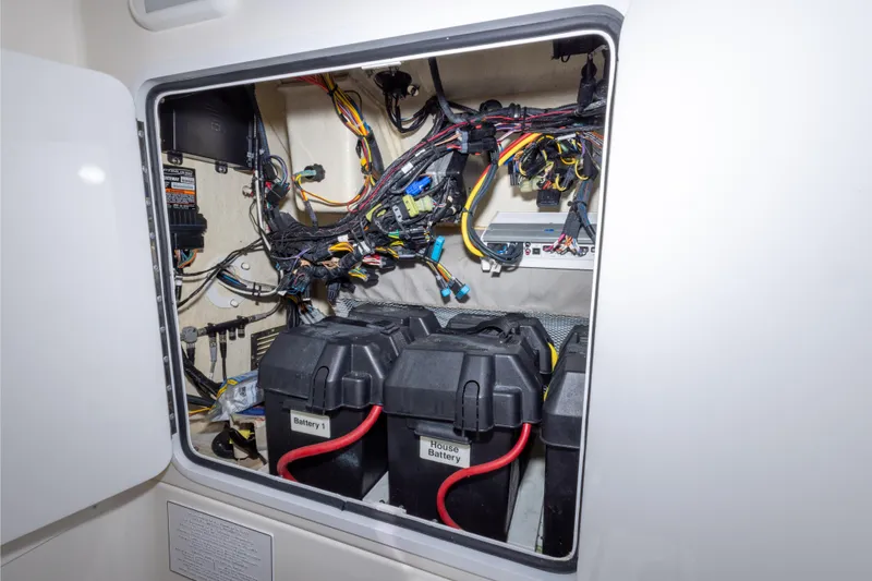 Slide: The Image of Electrical compartment of a 2018 Regulator 31 boat, featuring batteries and wiring. - 50