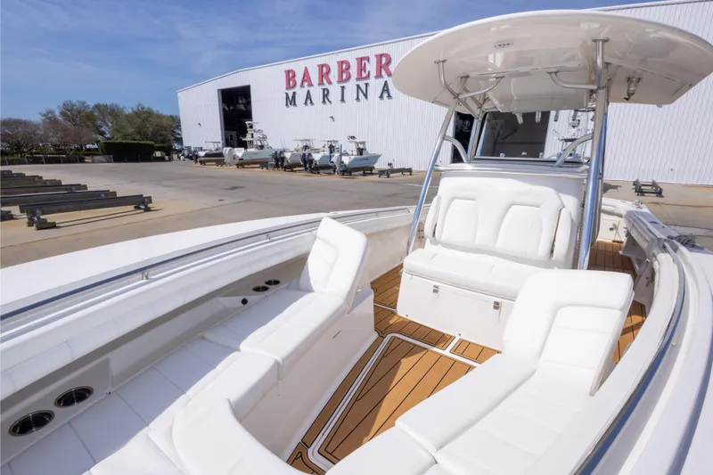 Slide: The Image of 2018 Regulator 31 boat at Barber Marina with white seating and wooden deck. - 53