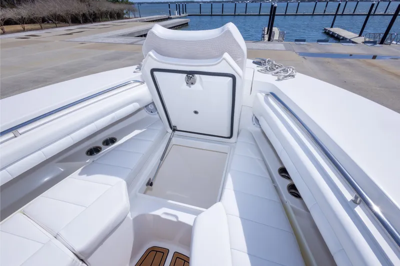 Slide: The Image of 2018 Regulator 31 boat interior with open storage compartment, dockside view. - 55