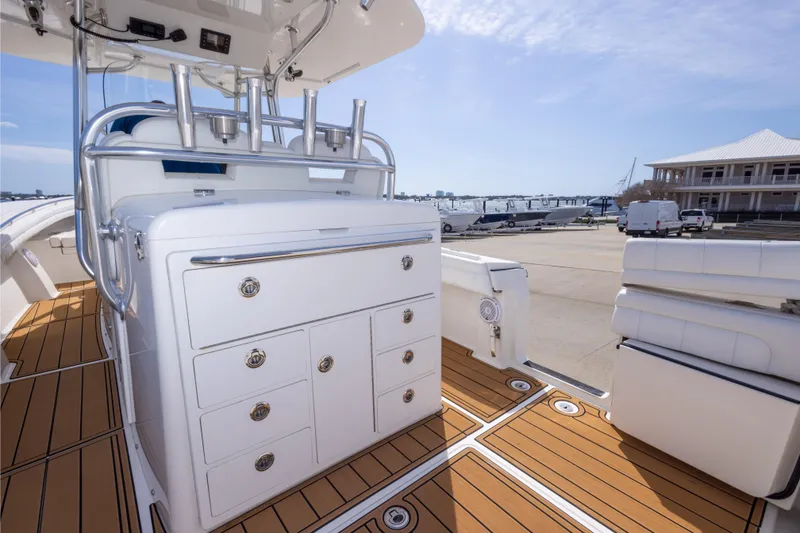 Slide: The Image of 2018 Regulator 31 boat interior with sleek cabinetry and teak flooring at a marina. - 57