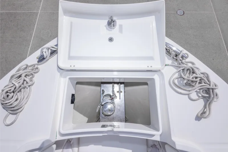 Slide: The Image of 2018 Regulator 31 boat anchor locker with ropes and storage compartment. - 61