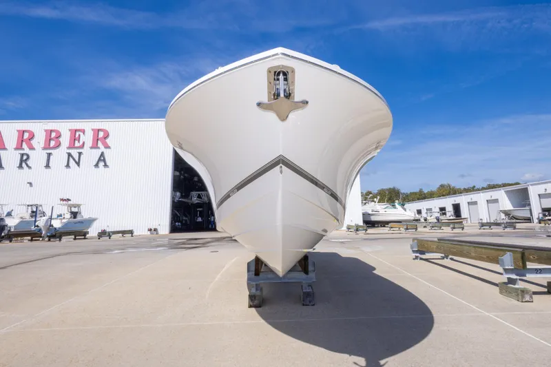 Slide: The Image of 2018 Regulator 31 boat at marina, front view under clear blue sky. - 9