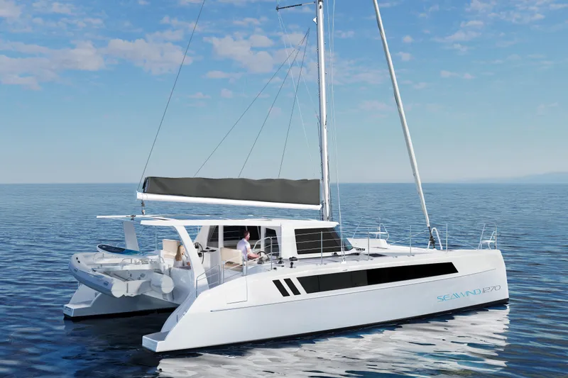 Slide: The Image of 2026 Seawind 1270 catamaran sailing on calm ocean under clear blue sky. - 14