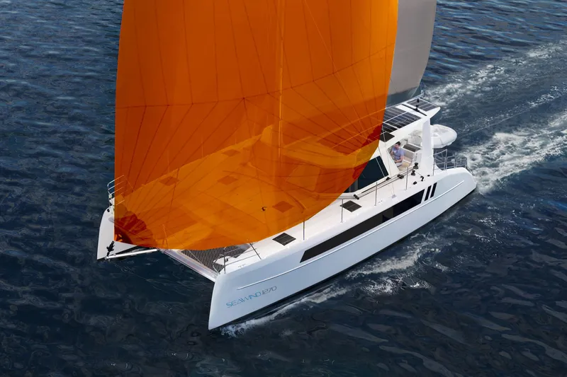 Slide: The Image of 2026 Seawind 1270 catamaran sailing with vibrant orange sail on open water. - 15