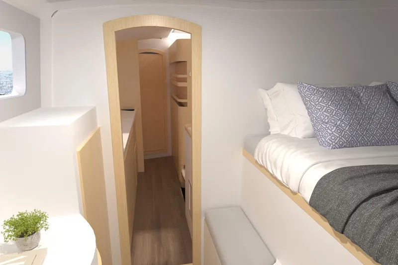 Slide: The Image of 2026 Seawind 1270 interior cabin with bed, wooden accents, and porthole view. - 25