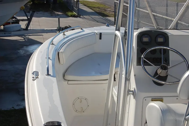 Slide: The Image of 2005 Sea Hunt Triton 220 boat interior with steering wheel and seating area. - 11