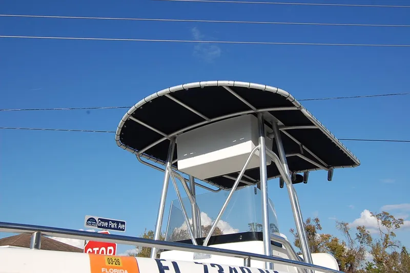 Slide: The Image of 2005 Sea Hunt Triton 220 boat with T-top against clear blue sky. - 4
