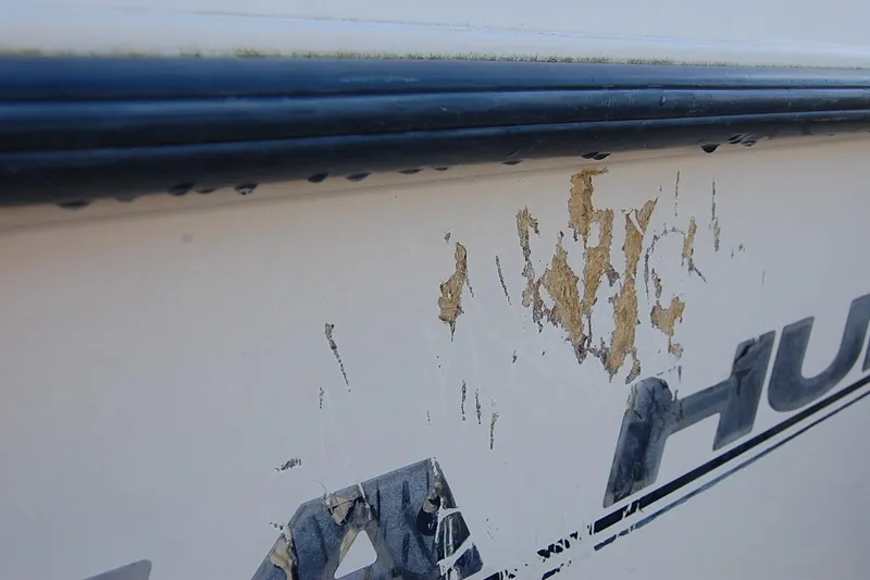 Slide: The Image of Close-up of damaged paint on 2005 Sea Hunt Triton 220 boat hull. - 7