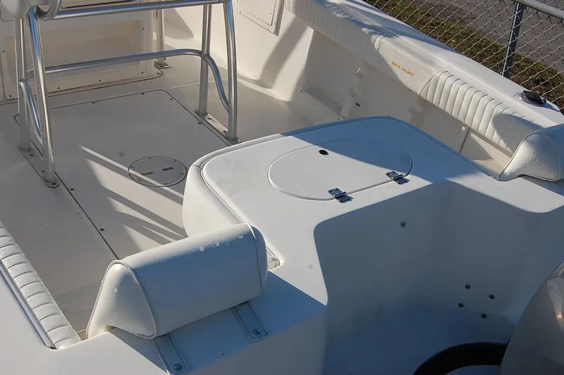 Slide: The Image of 2005 Sea Hunt Triton 220 boat interior with seating and storage compartments. - 9