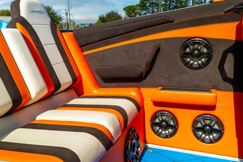 Slide: The Image of 2022 Cigarette 515 boat interior with orange and black seating, featuring multiple speakers. - 3