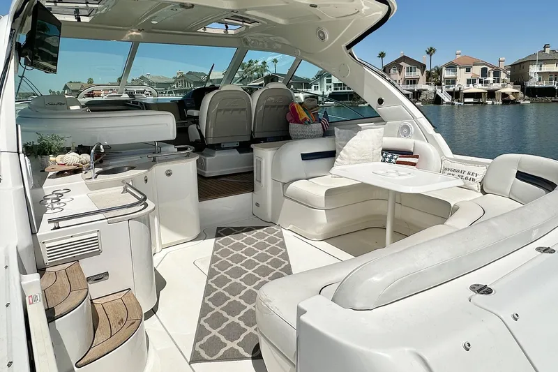 Slide: The Image of Interior of a 2008 Sea Ray 48 Sundancer yacht by the water. - 6