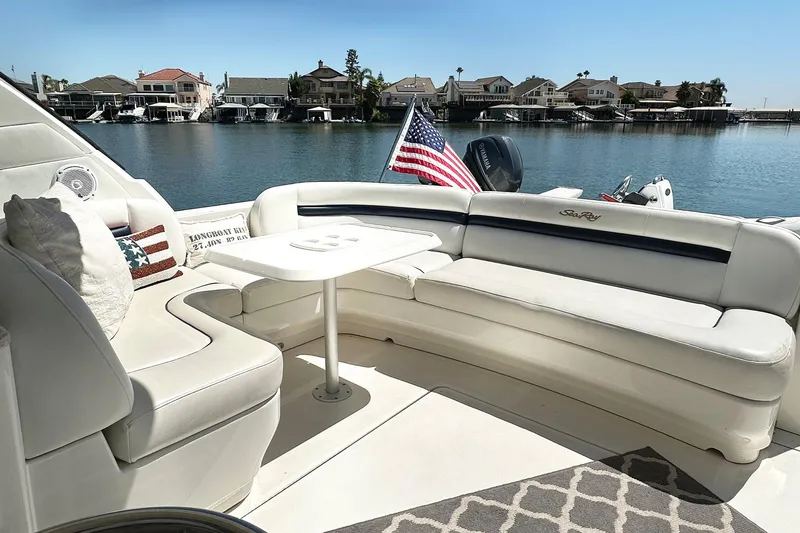 Slide: The Image of 2008 Sea Ray 48 Sundancer yacht with elegant seating area by the water. - 9