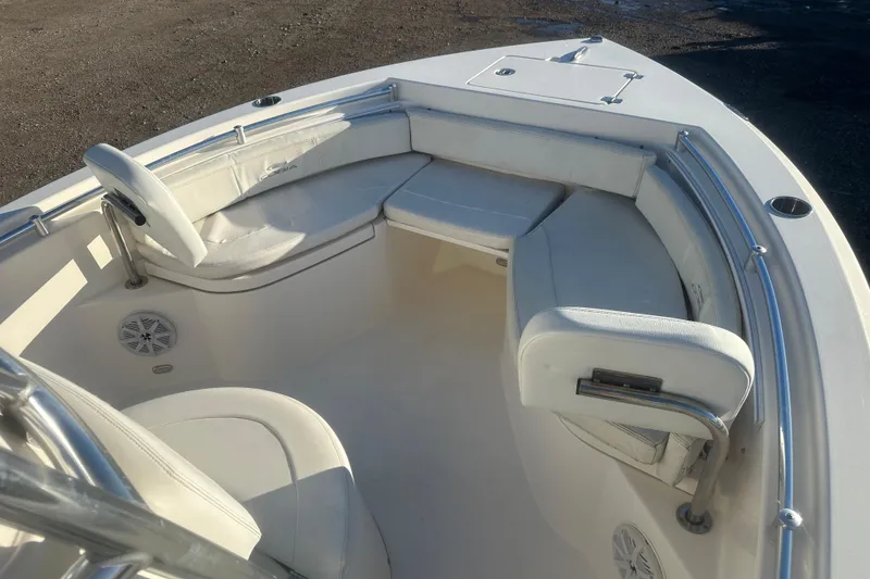 Slide: The Image of 2021 Cobia 220 Center Console boat interior with white seating and stainless steel railings. - 18