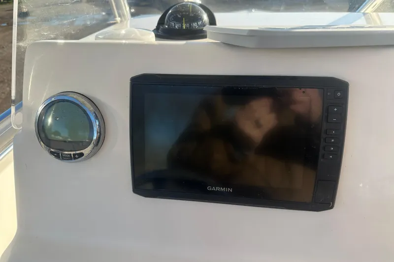 Slide: The Image of 2021 Cobia 220 Center Console dashboard with Garmin display and compass. - 19