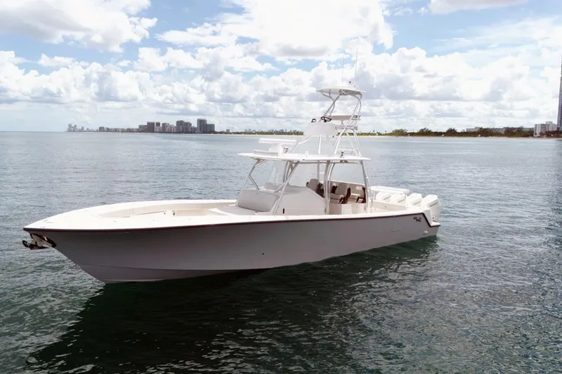 The Image of 2026 SeaVee 420Z boat on calm ocean waters under a partly cloudy sky. - 0