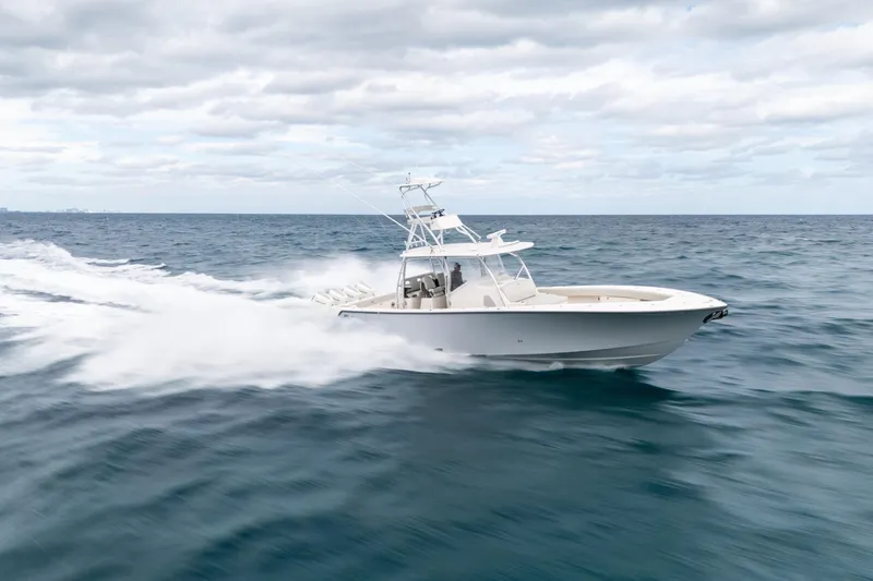 Slide: The Image of 2026 SeaVee 420Z boat cruising swiftly on open ocean under cloudy sky. - 10