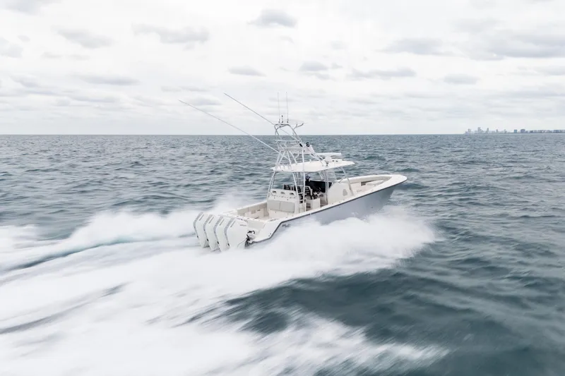 Slide: The Image of 2026 SeaVee 420Z boat speeding on open ocean under cloudy sky. - 12