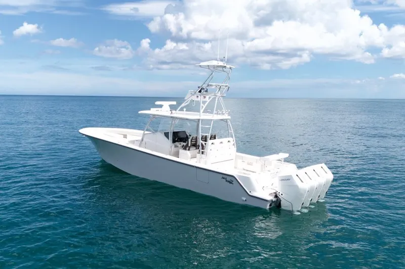 Slide: The Image of 2026 SeaVee 420Z boat cruising near city skyline under cloudy sky. - 2