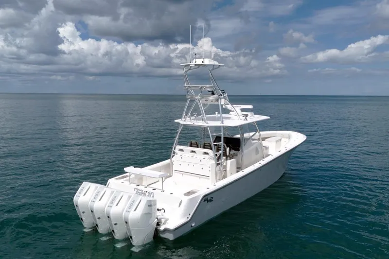 Slide: The Image of 2026 SeaVee 420Z boat with four engines on calm ocean waters. - 3