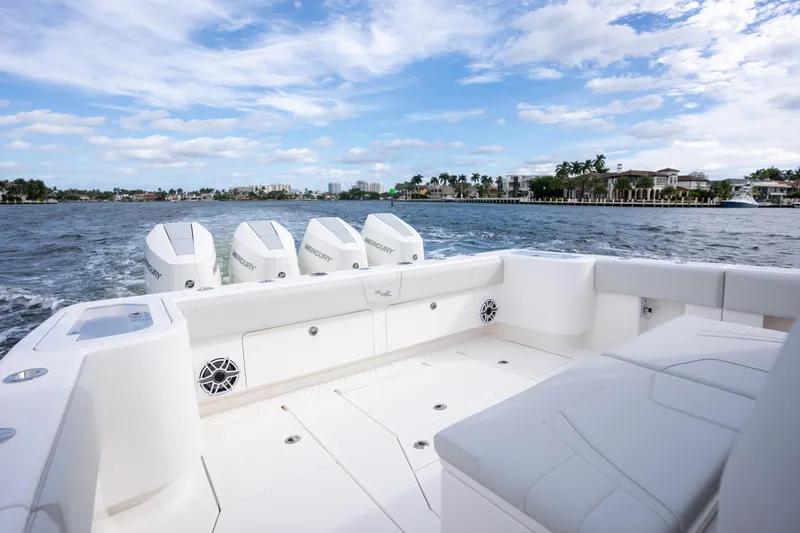 Slide: The Image of 2026 SeaVee 420Z boat with Mercury engines cruising on a scenic waterway. - 8