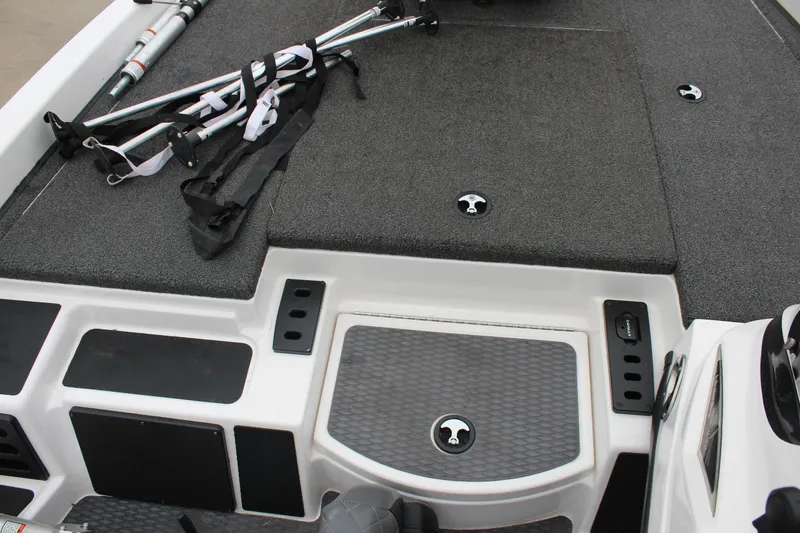 Slide: The Image of 2021 Caymas CX 18 SS boat deck with fishing rod holders and storage compartments. - 12