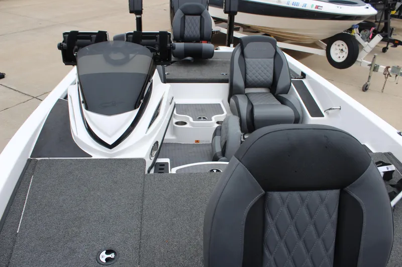 Slide: The Image of 2021 Caymas CX 18 SS boat interior with gray seating and carpeted deck. - 16