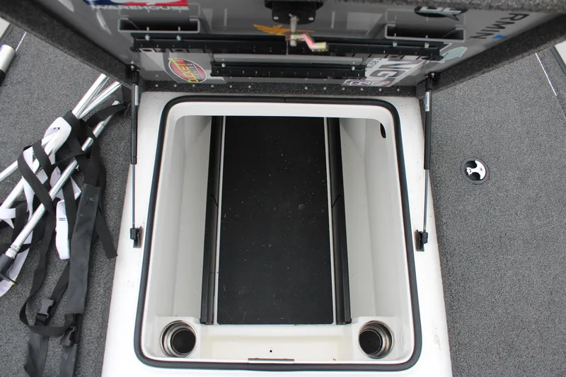 Slide: The Image of Open storage compartment in 2021 Caymas CX 18 SS boat, showing interior space. - 18