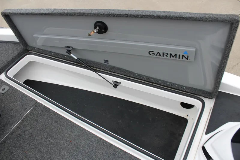 Slide: The Image of Open storage compartment in 2021 Caymas CX 18 SS boat with Garmin logo. - 19