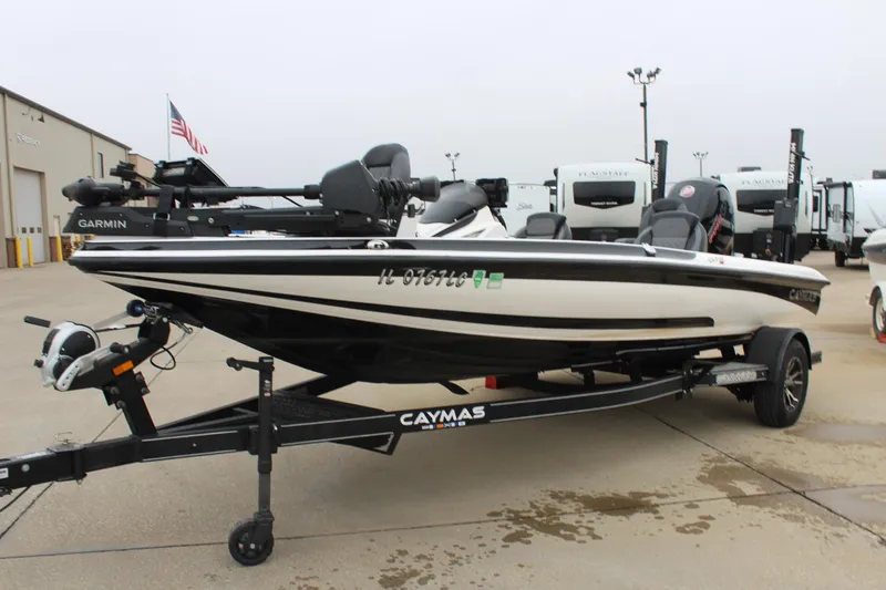 Slide: The Image of 2021 Caymas CX 18 SS boat on trailer, parked outdoors near RVs. - 3