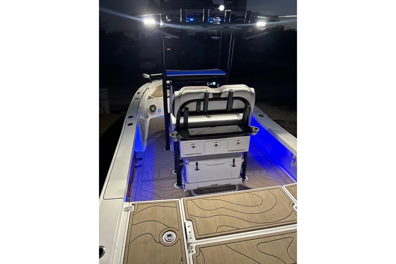 Slide: The Image of 2016 Crevalle 26 Bay boat parked near residential area under clear blue sky. - 10