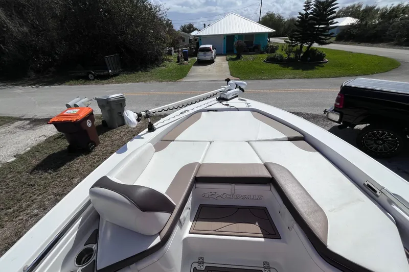 Slide: The Image of 2016 Crevalle 26 Bay boat parked in residential driveway, featuring spacious seating. - 15