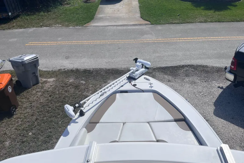Slide: The Image of 2016 Crevalle 26 Bay boat with trolling motor, parked on a driveway. - 22