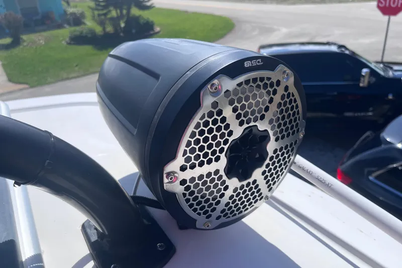 Slide: The Image of Close-up of a speaker on a 2016 Crevalle 26 Bay boat, featuring a hexagonal grille design. - 26