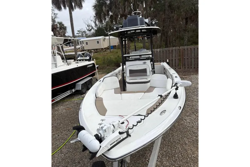 Slide: The Image of 2016 Crevalle 26 Bay boat on trailer with Yamaha engine, parked outdoors. - 3