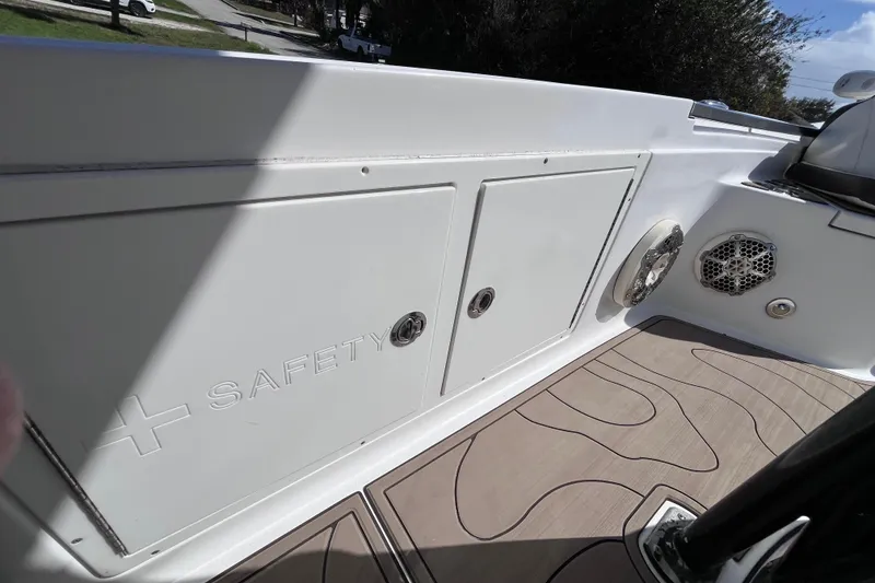 Slide: The Image of 2016 Crevalle 26 Bay boat interior with safety compartment and speaker. - 30
