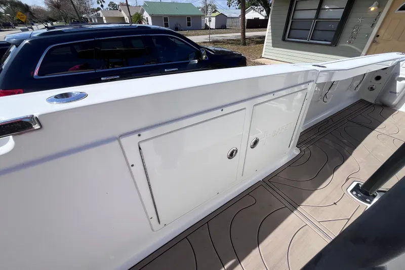 Slide: The Image of 2016 Crevalle 26 Bay boat interior with storage compartments and patterned flooring. - 32
